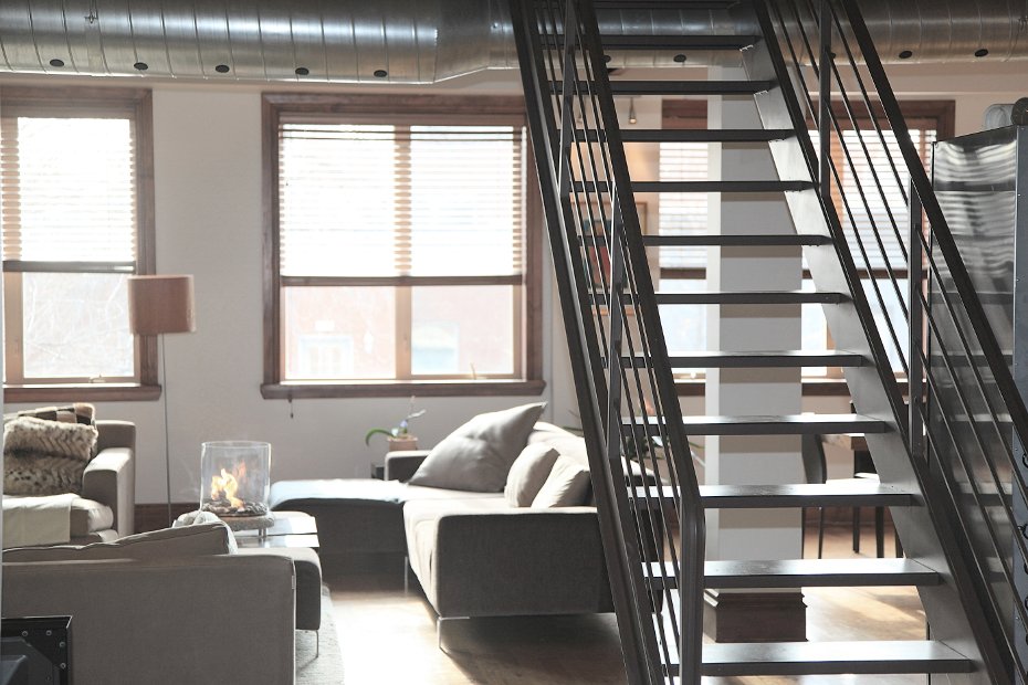 Modern loft with lounge furniture and staircase